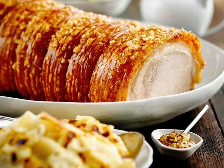 Roasted pork loin with crackling and creamy potato bake